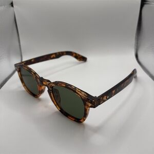 Leopard print round frame sunglasses with dark tinted lenses